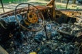 Burned out car, inside view, rusty steering wheel