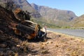 A burned out car next to a road in South Africa Royalty Free Stock Photo