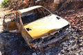 A burned out car next to a road in South Africa Royalty Free Stock Photo