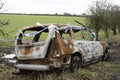 Burned out car on the roadside England UK Royalty Free Stock Photo