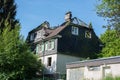 Burned out house with dilapidated roof structure with charred roof beams