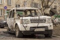 Burned out Land Rover car on the street. Based on the nature of the fire, hood torn from the