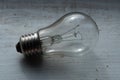 Burned out light bulb lying on the wooden painted surface Royalty Free Stock Photo