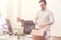 Burned out young man packing his things Royalty Free Stock Photo