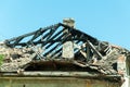Burned roof of abandoned civilian house in Eastern Ukraine damaged by grenade explosion in the war zone.