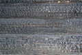 Burned wooden charred log house texture. closeup Royalty Free Stock Photo