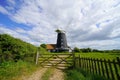 Black tower windmill in English village