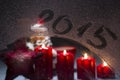 Burning advent candles on the frosted window with 2015 new year'