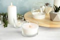 Burning aromatic candle and plants Royalty Free Stock Photo