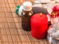 Spa background with red candle, massage oils and stones Royalty Free Stock Photo