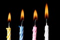 Burning birthday candles on black