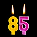 Burning birthday candles in the form of 85 eighty five figures for cake isolated on black background. The concept of celebrating a