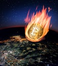 Burning bitcoin falling on the night globe Royalty Free Stock Photo