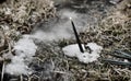 Burning black candle in snow in winter