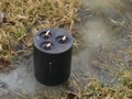 Burning black candle in water outside, magic wiccan ritual