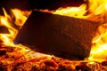 Burning black square board with open red fire flame