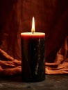 Burning black wax candle in dark magic atmospheric interior, front view candle mockup