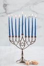 Burning blue candles on a Jewish menorah at Hanukkah