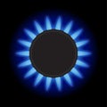 Burning blue flame gas burner on a black background. Top view. Royalty Free Stock Photo