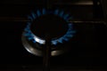 Burning blue gas on the dark stove. Burner gas stove, concept of energy. Closeup, selective focus Royalty Free Stock Photo