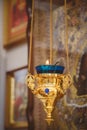 Burning blue and gold icon-lamp, candle in church on a icon background. Details in the orthodox christian church