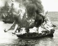 Burning boat in the middle of the ocean