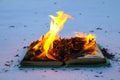 Burning book in snow. pages with the text in open book burn with bright flame Royalty Free Stock Photo