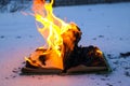 Burning book in snow. pages with the text in open book burn with bright flame