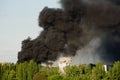 Burning building with black smoke. Huge smoke clouds after explosion