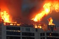 Burning building. Fire. Wirfire. Burning house at night, roof of building in flames and smoke. Royalty Free Stock Photo