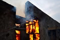 Burning building. Fire. Wirfire. Burning house at night, roof of building in flames and smoke.