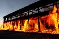 Burning building. Fire. Wirfire. Burning house at night, roof of building in flames and smoke.