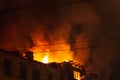 Burning building at night, roof of house in fire flames Royalty Free Stock Photo