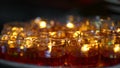 Burning prayer candles in Asian Buddhist Temple. Royalty Free Stock Photo