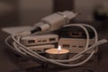 A burning candle against the background of power banks and a charger Royalty Free Stock Photo