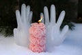 Burning candle on the background of hands made of ice Royalty Free Stock Photo