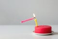A burning candle bends down to light another. Space for text. Royalty Free Stock Photo
