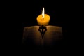 Burning candle and Bible . Christian cross . Royalty Free Stock Photo