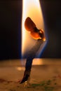 Burning candle on black background close-up. Royalty Free Stock Photo