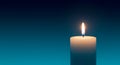Burning Candle on a Blue Background Royalty Free Stock Photo