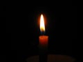 Burning candle in center position and dark background, copyspace. Royalty Free Stock Photo