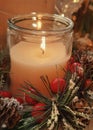 Burning candle and Christmas decoration. Christmas or Advent background with candle and fir branches Royalty Free Stock Photo
