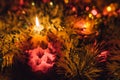 Burning candle and Christmas decoration. Elegant low-key shot with festive mood Royalty Free Stock Photo