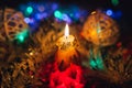 Burning candle and Christmas decoration. Elegant low-key shot with festive mood Royalty Free Stock Photo