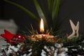 Burning candle and Christmas decoration over snow and wooden background, elegant shot with festive mood Royalty Free Stock Photo