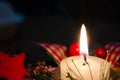 Burning candle and Christmas decoration over snow and wooden background, elegant shot with festive mood Royalty Free Stock Photo