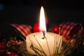 Burning candle and Christmas decoration over snow and wooden background, elegant shot with festive mood Royalty Free Stock Photo