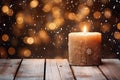 Burning candle, Christmas decoration on wooden background in falling snow and defocused lights background. Copy space Royalty Free Stock Photo