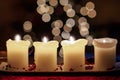 Burning candle with christmas tree bokeh Royalty Free Stock Photo