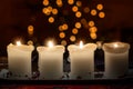 Burning candle with christmas tree bokeh Royalty Free Stock Photo